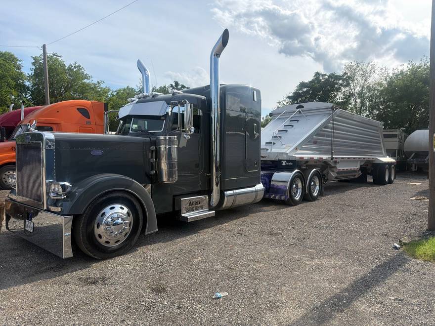 AREN gray Peterbilt hauling a hopper belly-dump trailer